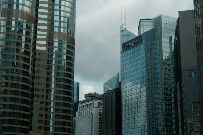 Modern skyscrapers with glass facades under cloudy sky